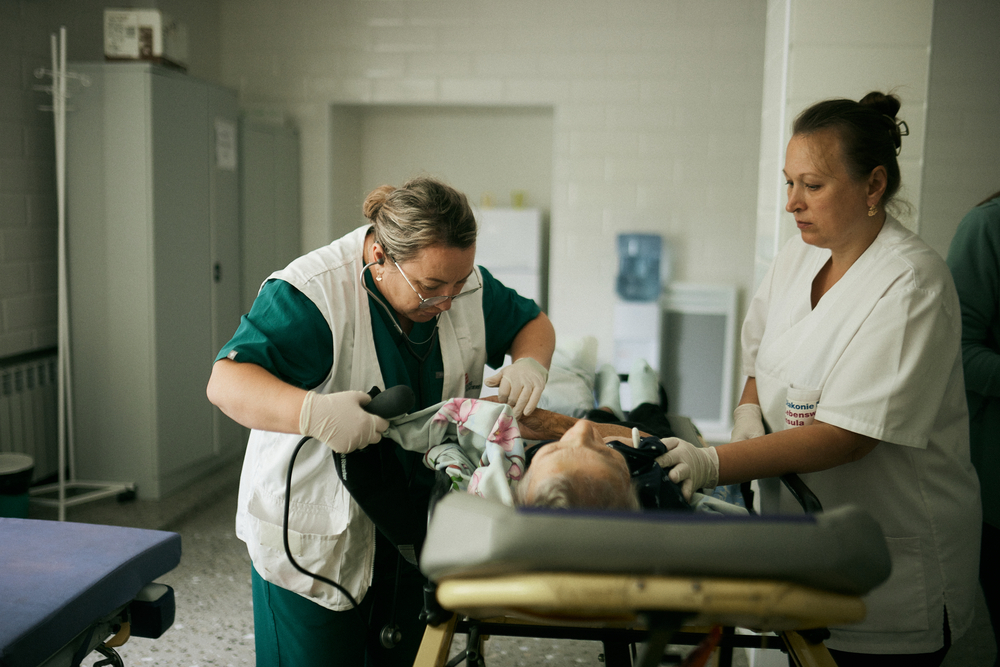 MSF staff are taking care of a 84 year old patient just admitted by ambulance at one of the hospitals in Mykolaiv region
