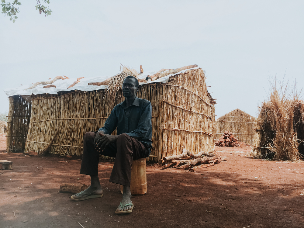msb125359_medium.jpg Jean-Claude poses in front of his shelter at the Bogouyo IDP site.