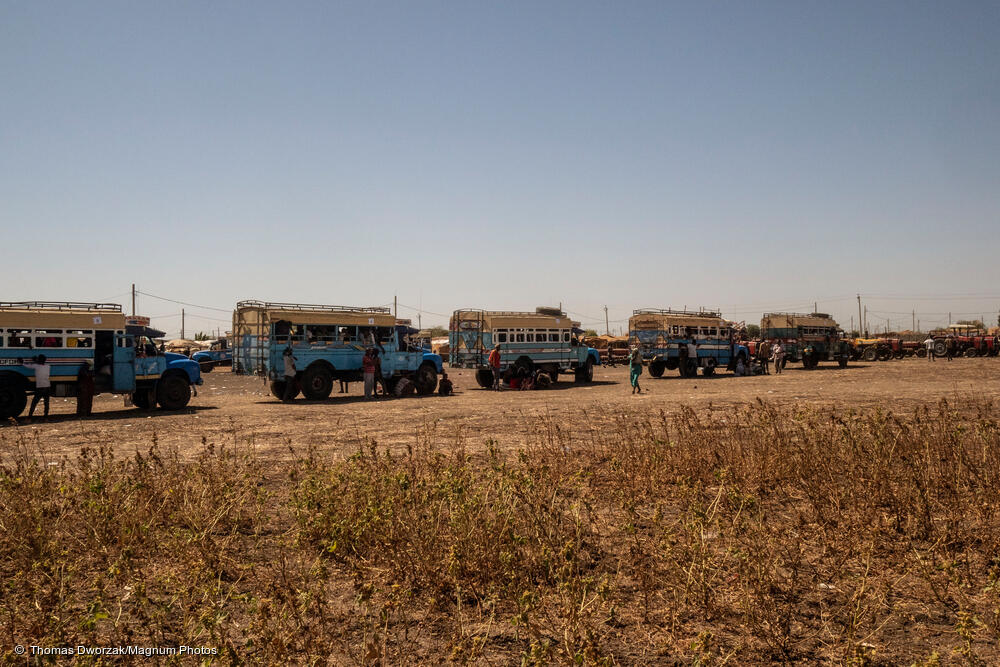 msb38309_medium.jpg Buses transfer refugees from Al Hashaba transit camp to Um Rakuba refugee camp.