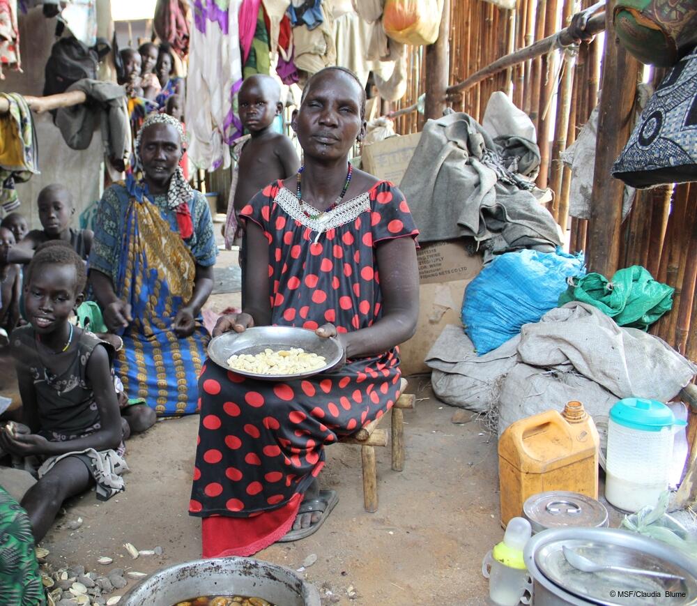 msb64506_medium.jpeg Nyachuol* prepares a meal of forest fruits for her children