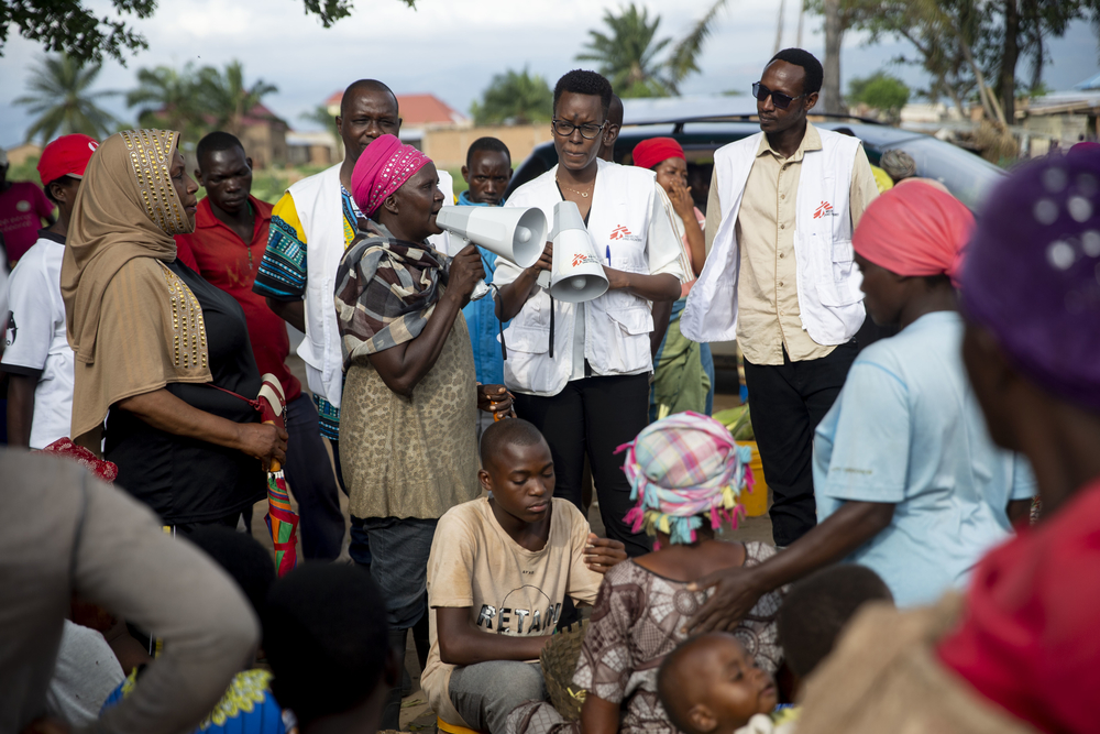 A community health worker with a megaphone raises awareness about cholera in Bujumbura’s Buterere market. [ Evrard Ngendakumana/MSF]