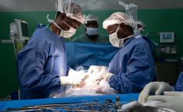 Surgeons at the Rutshuru General Reference Hospital cauterize a wound of a young gunshot victim.