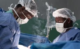 Surgeons at the Rutshuru General Reference Hospital cauterize a wound of a young gunshot victim.