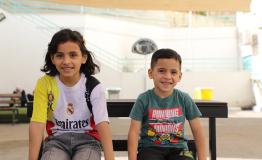 Omar sits with his sister in the playground at the reconstructive surgery hospital in Amman, Jordan. Omar was injured in an Israeli strike, after a piece of shrapnel tore through his leg.