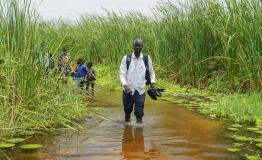 MSF paramedicine nurse Ghan Paul Hoth walks through floodwaters
