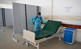 Mwachiro Ngala Mangale, hygeinist disinfecting a patient bed in the severe adult male ward at Utange isolation center.