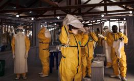 msf251456_custom.jpg Health workers putting on their personal protective equipment (PPE) before entering in the red zone of the ETC in Butembo, DRC