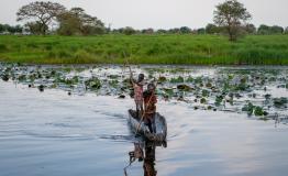 Young boys steer a canoe in Old Fangak, South Sudan. [© Florence Miettaux]