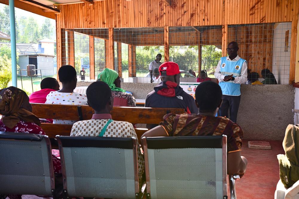 Meshak Aoko, a community health promoter takes patients through a health education session in Nyalkinyi Health Center under the differentiated service delivery model