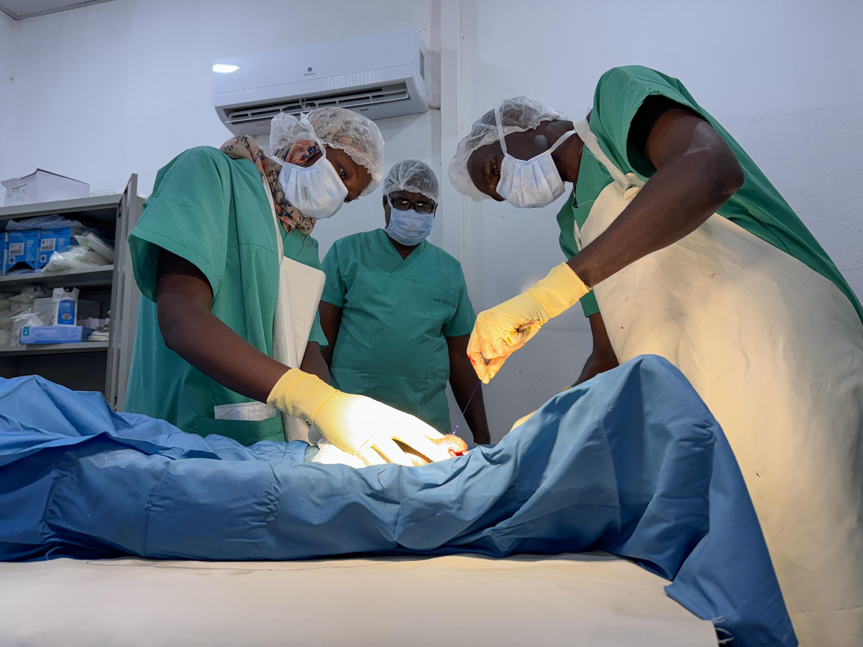 3 Sudanese Colleagues perform a follow-up surgery on a patient amputation