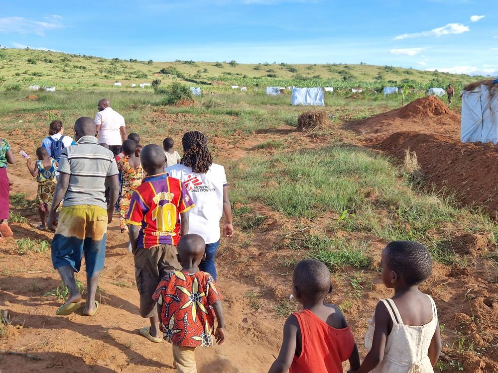 MSF staff with refugees in Kabwera new settlement, Nakivale camp.