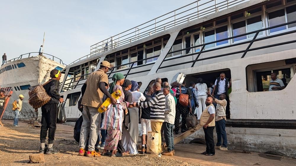 People jump on a ship at the port of Bukavu, capital of South Kivu province, eastern Democratic Republic of Congo. Some navigation through Lake Kivu was restablished today 18 February 2025