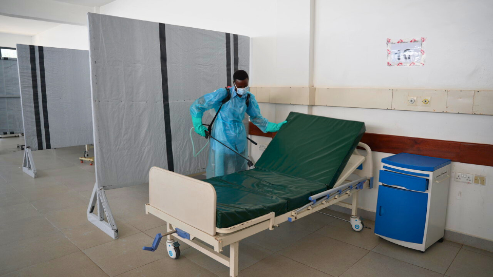 Mwachiro Ngala Mangale, hygeinist disinfecting a patient bed in the severe adult male ward at Utange isolation center.