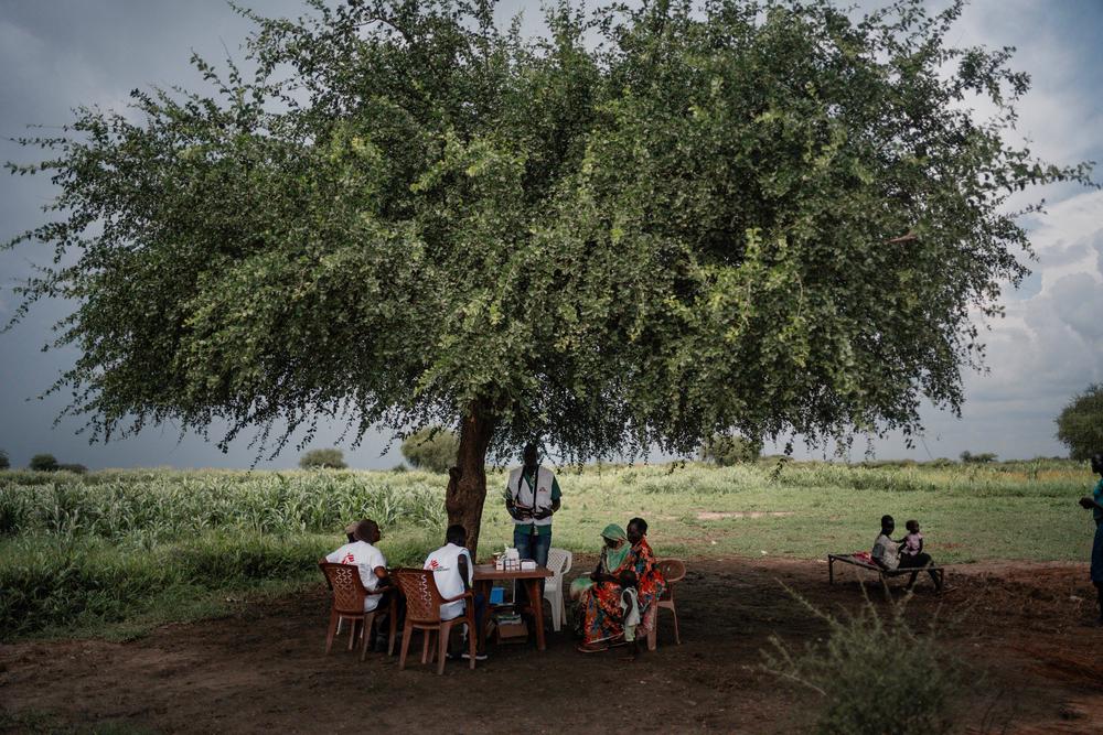 Aid post under a tree, Khadian village. 