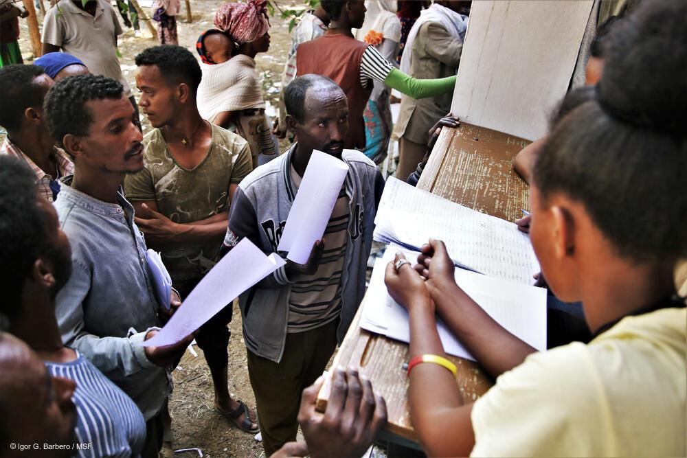 Administrators register newly arrived displaced people at Tsegay Berhe