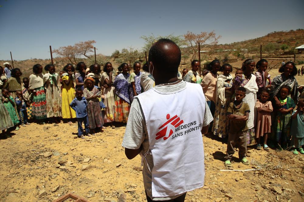 An MSF translator gives instructions to women waiting with their children for a medical consultation