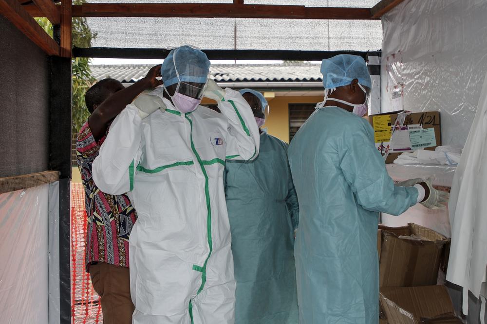Medical staff dress with PPE to enter the treatment unit 