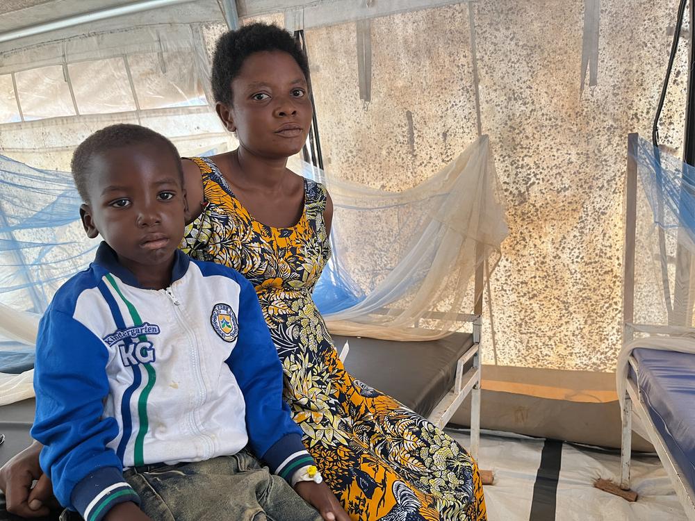 Seven-year-old Crispin Uhuru and his 37-year-old mother, Judith Zabibu, are sitting in the paediatric ward set up by Médecins Sans Frontières (MSF) at Gihofi Hospital. Crispin is suffering from severe malaria. They both come from the Musenyi refugee site.