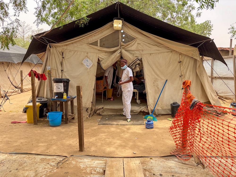 An MSF staff member stands outside the paediatric isolation tent at Adré Hospital, where children with severe measles receive intensive care in a dedicated 15-bed unit. Paediatric isolation ward, Adré Hospital, Ouaddaï Province, Chad.