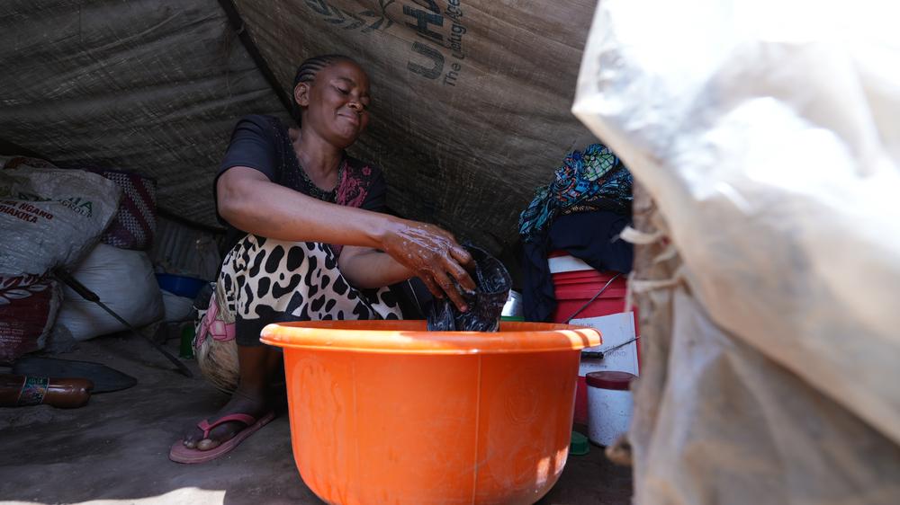 Asiya Bipemacho, 30, does the laundry in the tent she shares with her family in the Busuma refugee camp. “At night, worry often keeps me awake. I constantly think about how I will find enough food to feed my family. I want to return home to Uvira [in the Democratic Republic of the Congo], but until I am selected for repatriation, I have to remain here, where life is very difficult. I hope I can return home as soon as possible.”