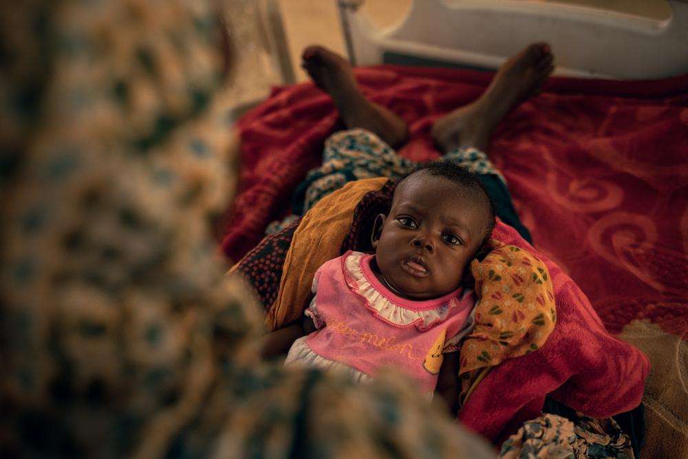 Sara Oumar, 75 days old, lies in the arms of her mother, Koubra Abderahaman, whose age is unknown and estimated at around 25, Chadian. 