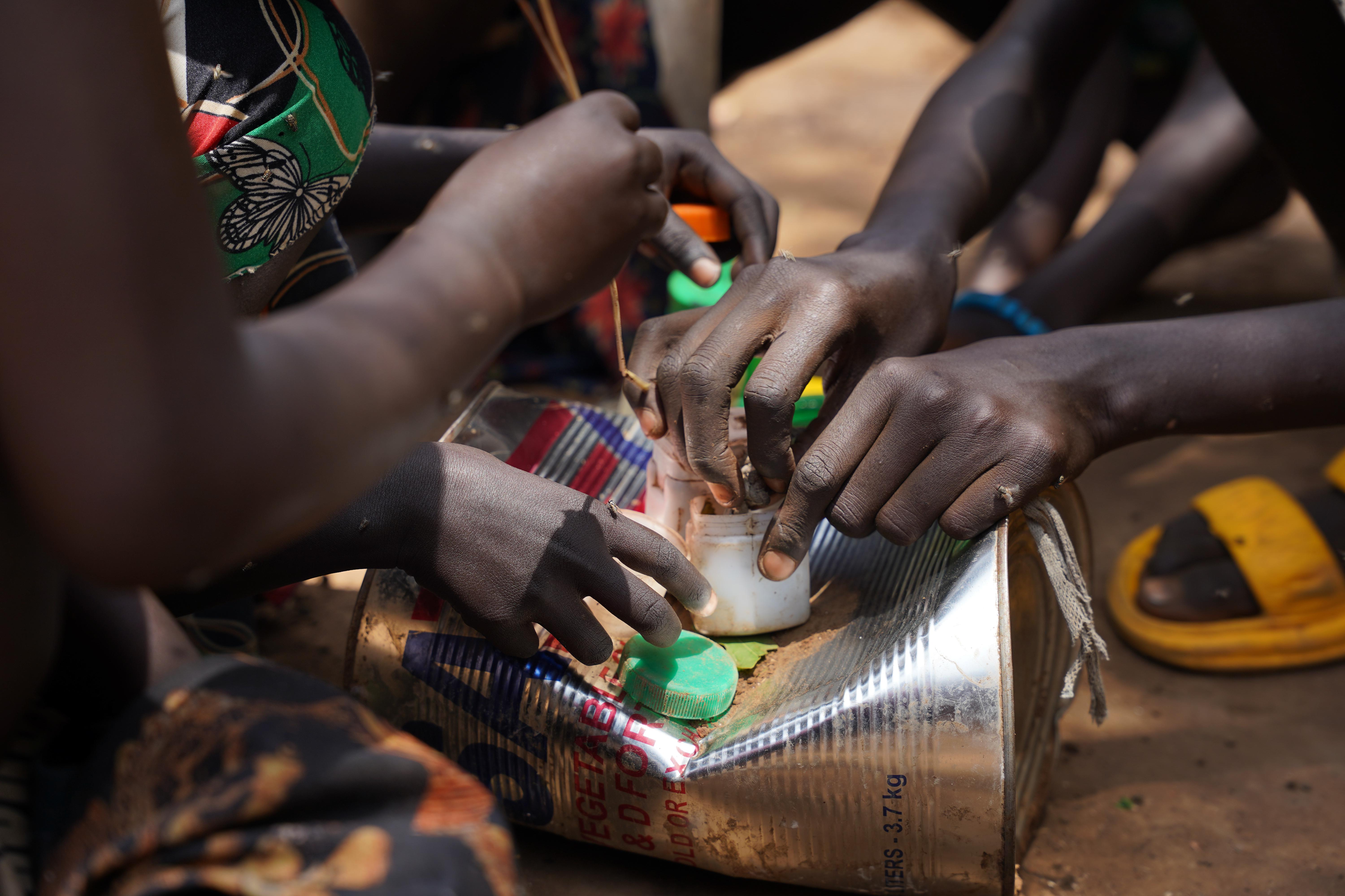 Kids playing using bottle caps as toys in Kule Refugee Camp, Gambella Region, Ethiopia. 2026