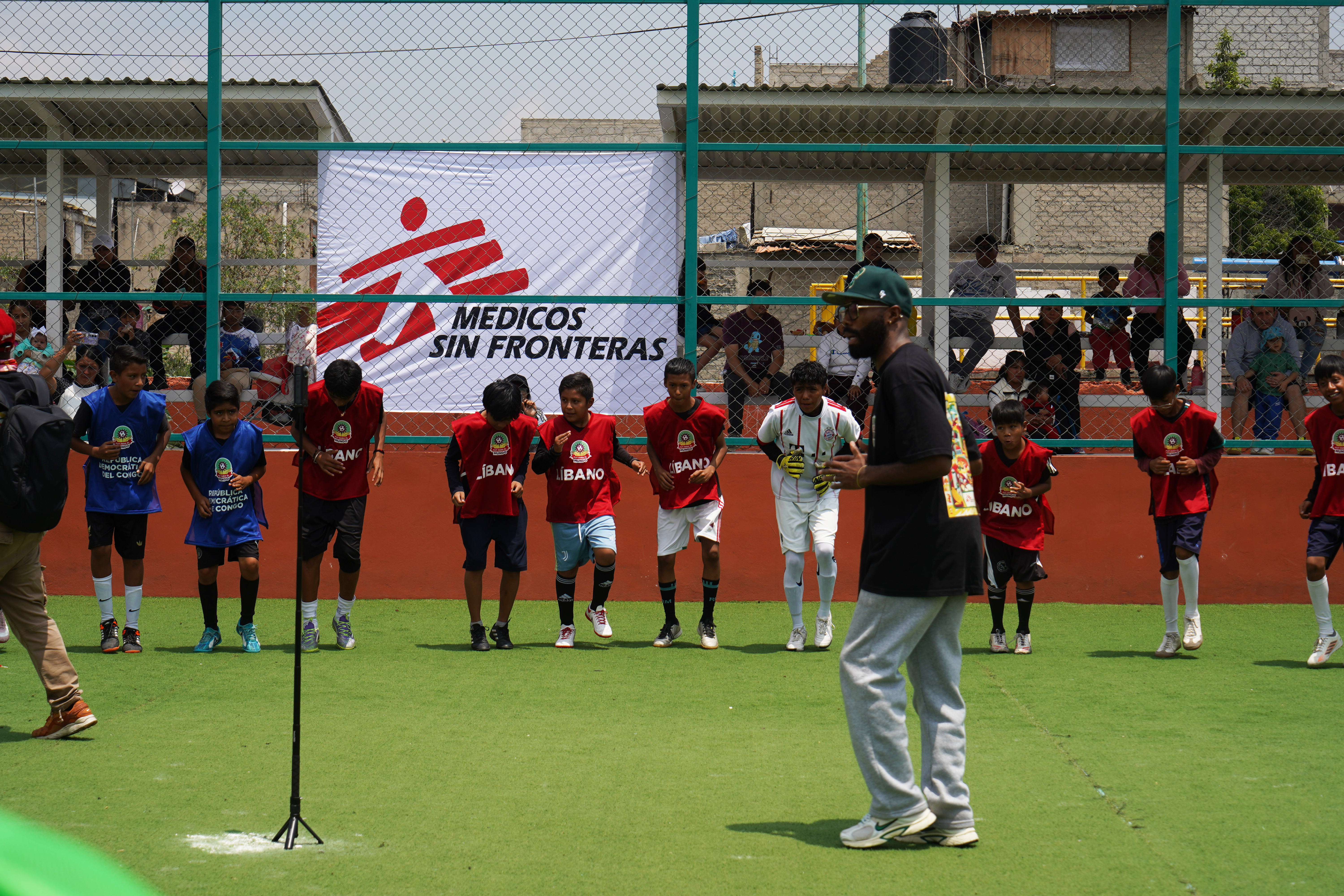 A trainer was called to help the kids warm up before and during the matches, with those not actively playing in those moments.